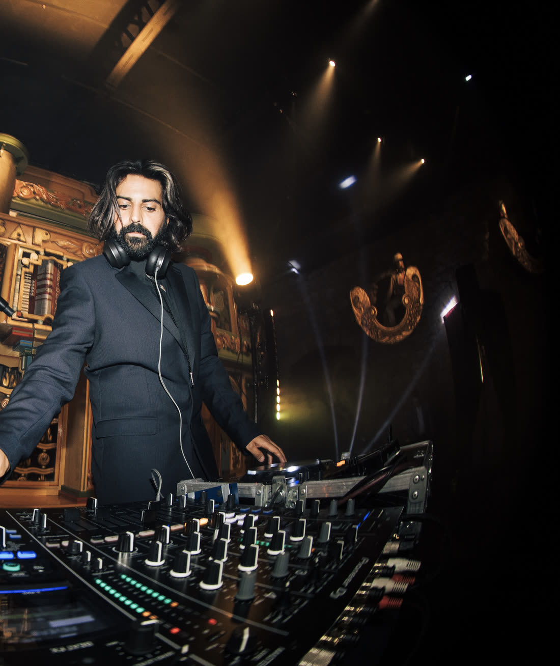 ZANAVI at the mixer under gold spotlights in an ornate club