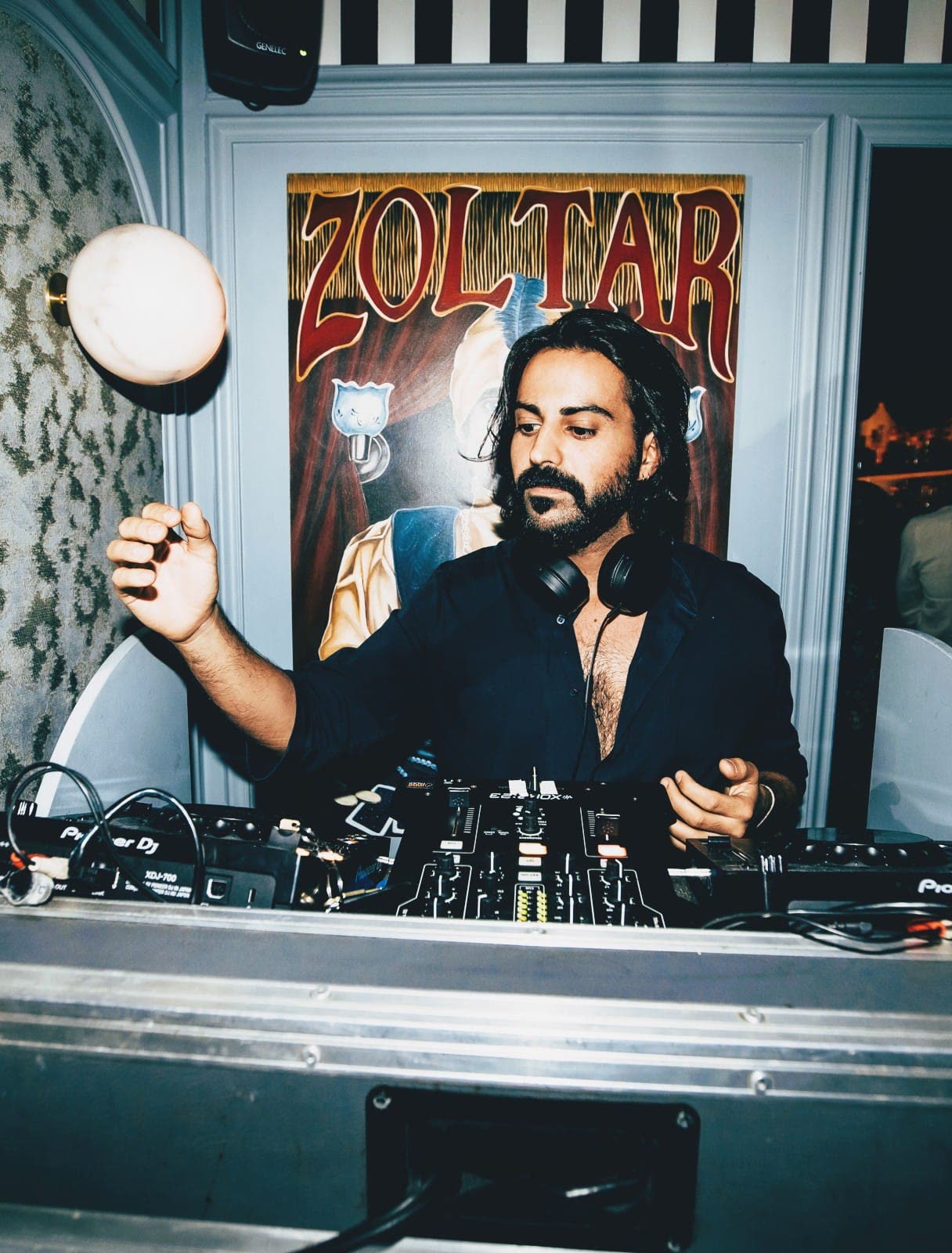 ZANAVI playing a party in an open black shirt